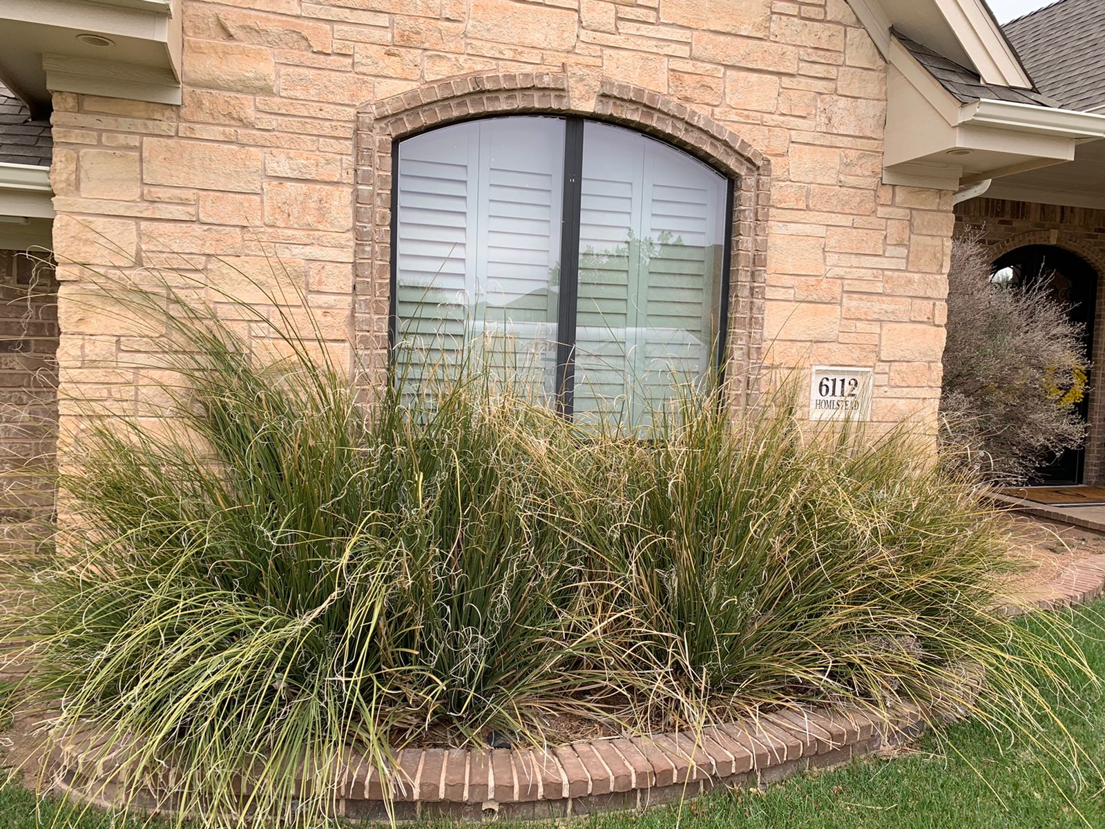 ProVia Endure vinyl replacement windows on a stone-veneer home